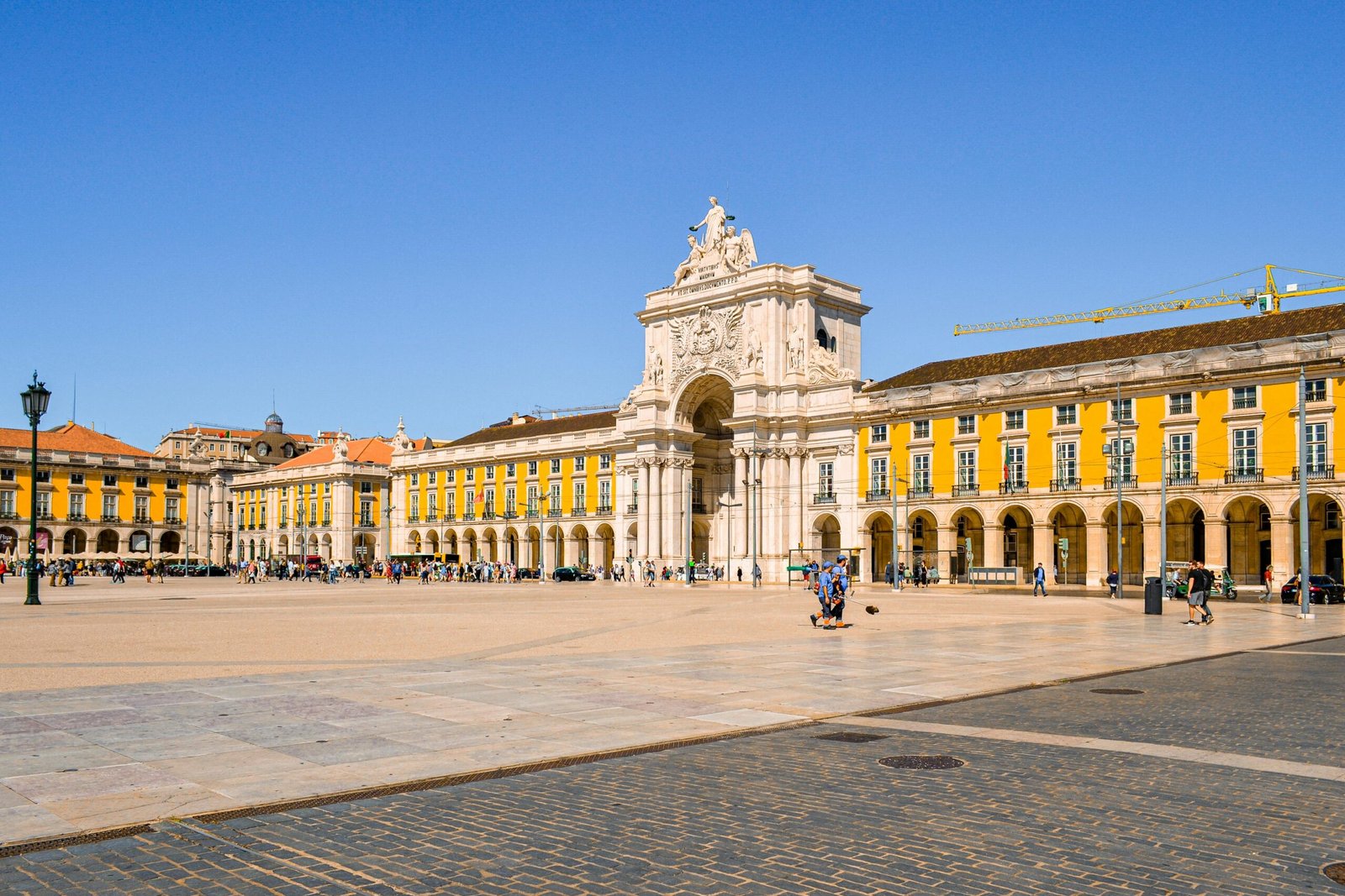 Vibrant view of Praca do Comercio and Rua Augusta Arch in Lisbon, Portugal, on a sunny day.